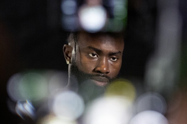 Boston Celtics' Jaylen Brown sits for a television interview during the NBA basketball team's media day, Monday, Oct. 2, 2023, in Boston. (AP Photo/Michael Dwyer, File)